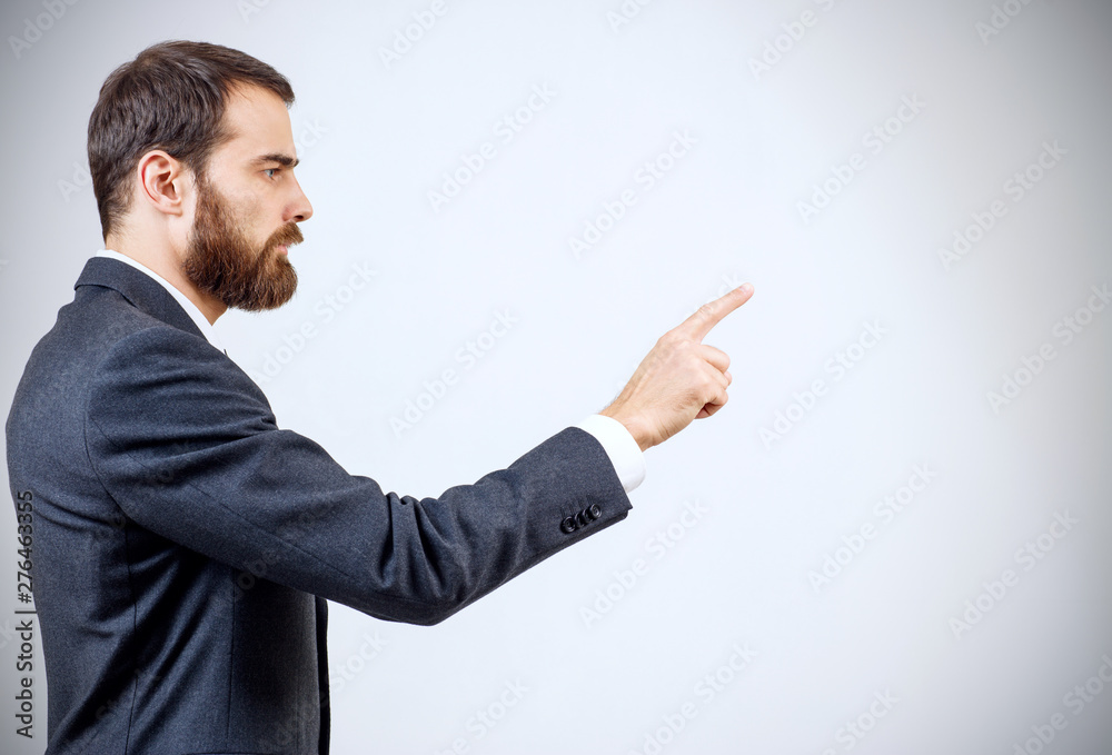 Businessman pointing to something or touching by forefinger. Businessman pointing to something or touching by forefinger.