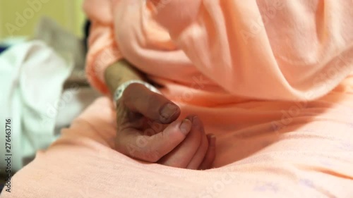 Elderly woman hospital gown IV hands photo