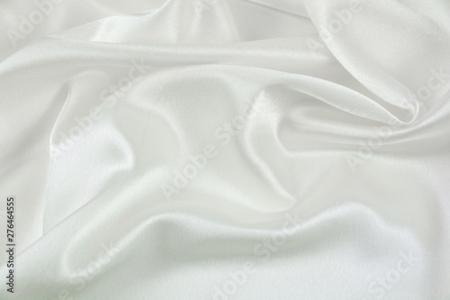 The texture of the satin fabric of white color for the background