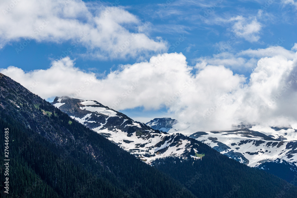 alpine landscape view from Garibaldi provincial park with peaks covered by snow and clouds.