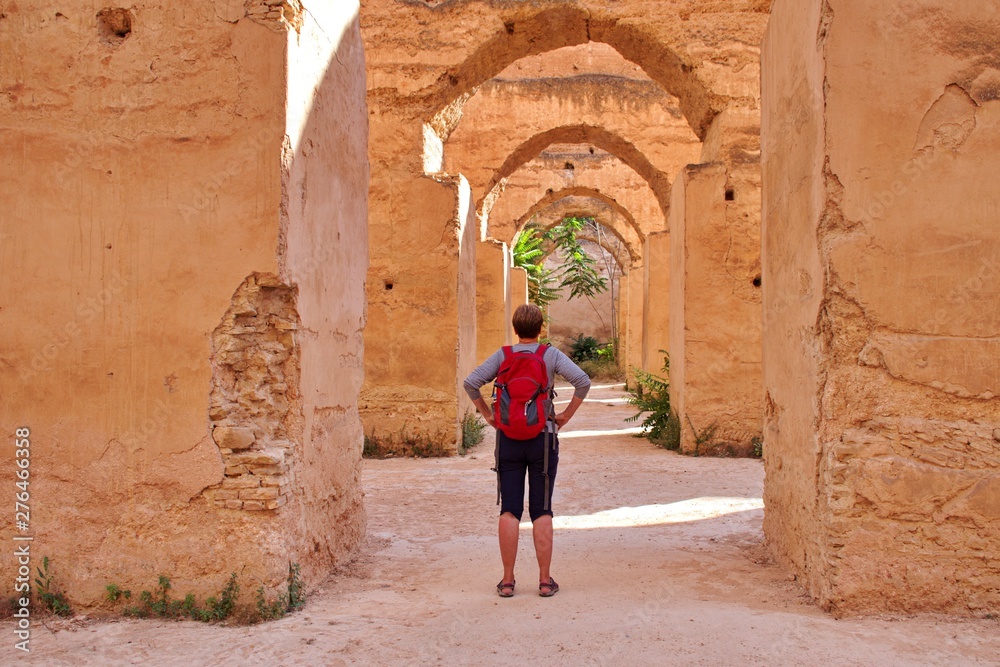 Ruins and arches in Meknes, Morocco - Rear view of the woman