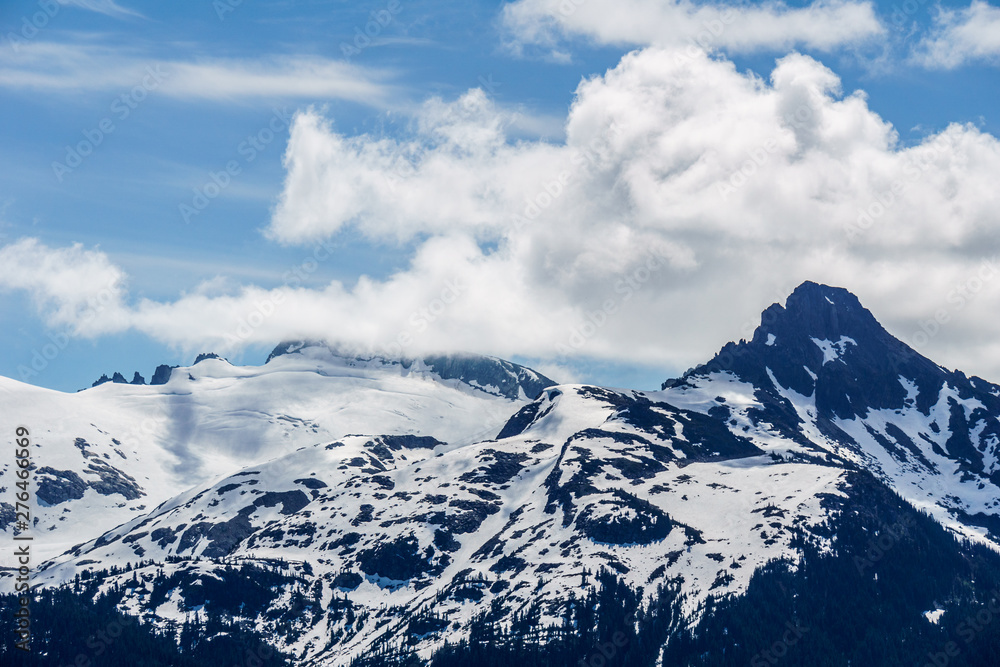 alpine landscape view from Garibaldi provincial park with peaks covered by snow and clouds.