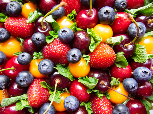 Fototapeta Naklejka Na Ścianę i Meble -  background of fresh cherries, strawberries, blueberry and physalis