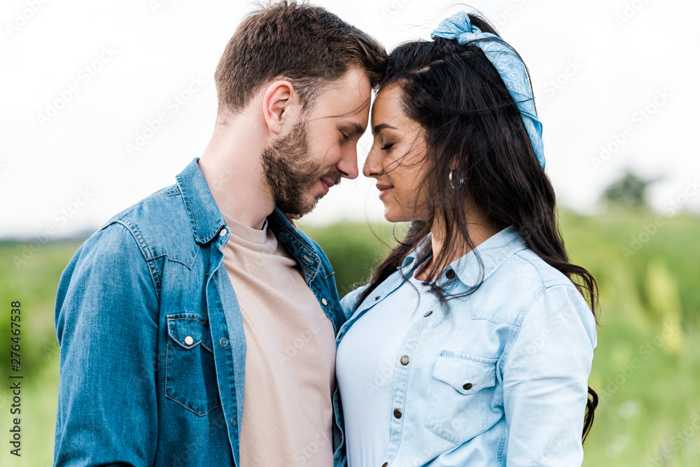 happy man and woman with closed eyes standing together happy man and woman with closed eyes standing together