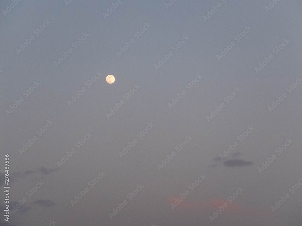 Full moon in the dark blue evening sky Full moon in the dark blue evening sky