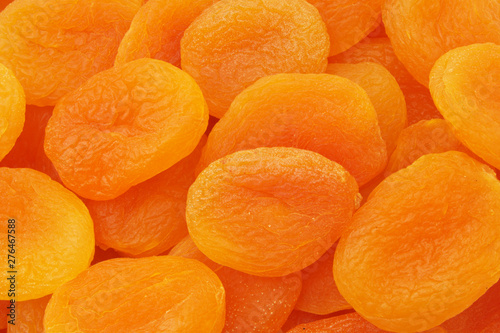 Many dried apricots fruits as background
