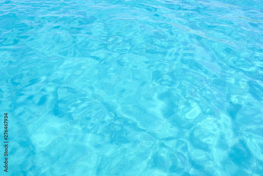 Close-up view of a transparent turquoise sea water that forms a natural texture, Emerald Coast, Sardinia, Italy.