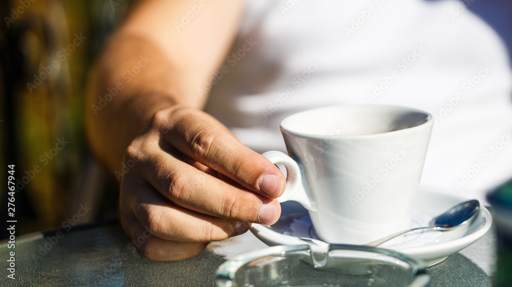 Cup of coffee. Cappuccino and black espresso coffe cup. Coffee drink. Close up of a man hands holding a hot coffe cups. Coffe time. Hand of man hold coffee or coffe cup at cafe in the morning. Closeup