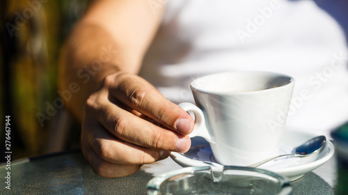 Cup of coffee. Cappuccino and black espresso coffe cup. Coffee drink. Close up of a man hands holding a hot coffe cups. Coffe time. Hand of man hold coffee or coffe cup at cafe in the morning. Closeup