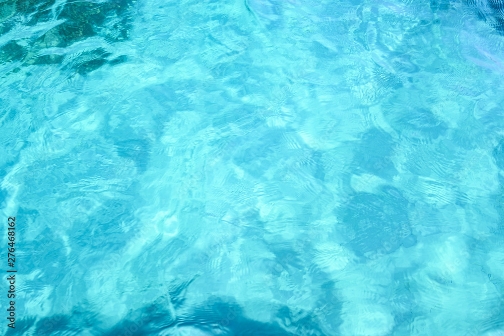 Close-up view of a transparent turquoise sea water that forms a natural texture, Emerald Coast, Sardinia, Italy.