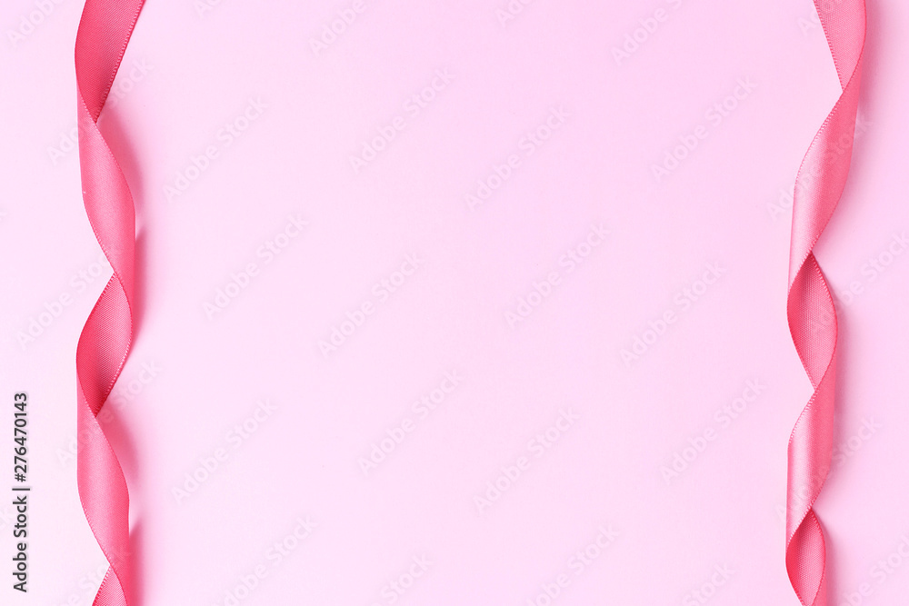 Two gift ribbons on a pink background, copy space