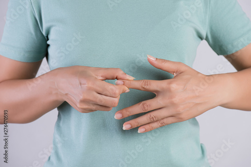 Healthcare and medical concept. Woman massaging her painful Index finger.