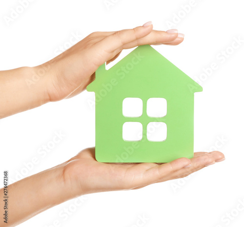 Female hands with figure of house on white background. Mortgage concept