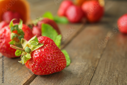 Sweet ripe strawberry on wooden background