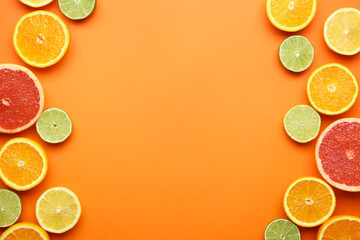 Many different citrus fruits on color background