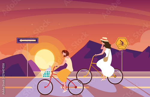 women riding bike in sunrise landscape with signage for cyclist