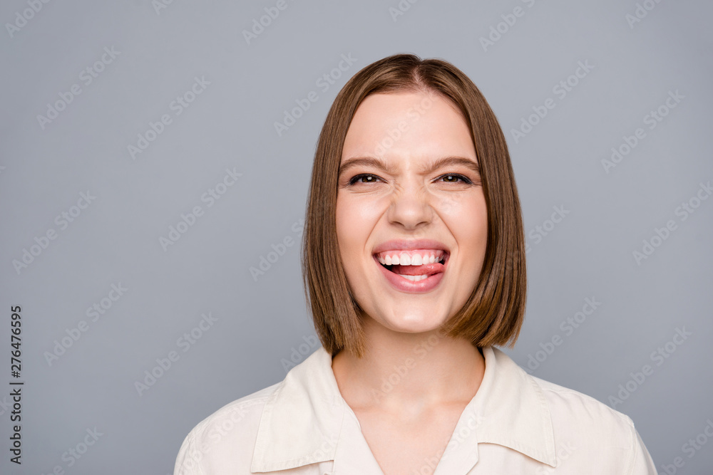 Close up photo amazing crazy she her lady playful funny facial expression tongue out mouth toothy impolite childish tricky person giggling laughter wear casual white shirt isolated grey background Close up photo amazing crazy she her lady playful funny facial expression tongue out mouth toothy impolite childish tricky person giggling laughter wear casual white shirt isolated grey background