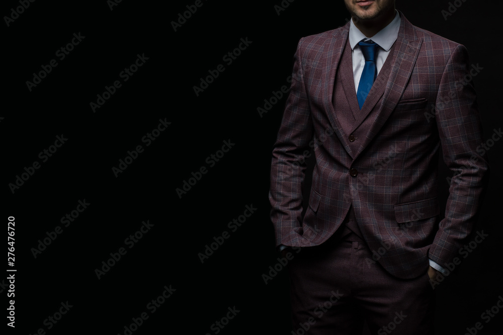 Middle aged successful business person in a suit on dark background, copy space. Middle aged successful business person in a suit on dark background, copy space.