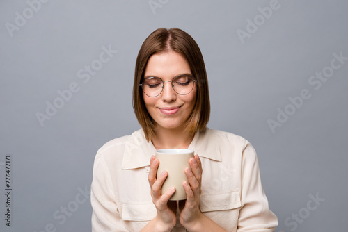 Close up photo beautiful amazing cute she her business lady hands arms hot beverage lunch free time eyes closed overjoyed wear eyewear eyeglasses specs casual white shirt isolated grey background