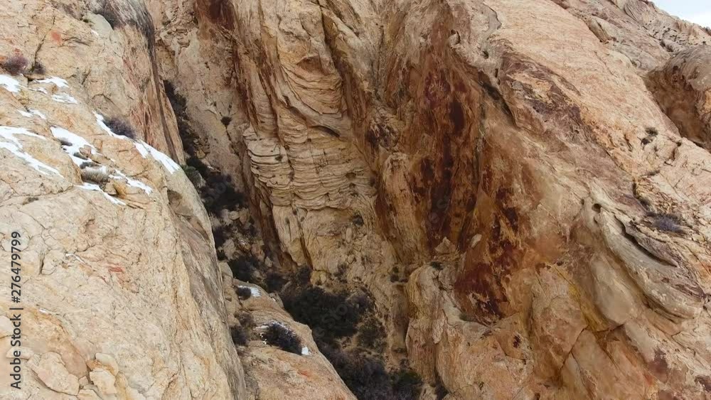 Desert mountain geologic cliffs snow - rotating aerial view Desert mountain geologic cliffs snow - rotating aerial view