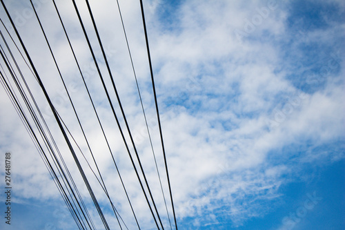 electric pole and electric wire on blue sky background. © jajam_e