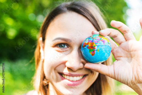 young woman holding small globe