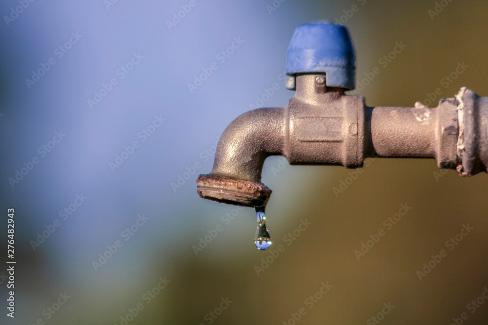 drop falling from the tap. Water is a very precious resource, not to be wasted - obrazy, fototapety, plakaty 