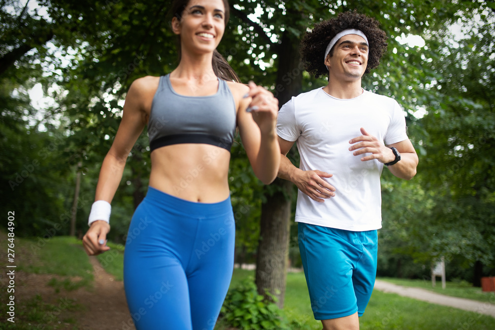Fototapeta premium Happy young people jogging and exercising in nature