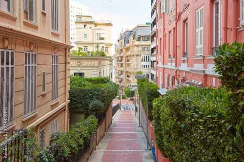 Fototapeta Naklejka Na Ścianę i Meble -  Narrow pedestrian alley in Monte Carlo with luxury buildings, summer day in Monaco