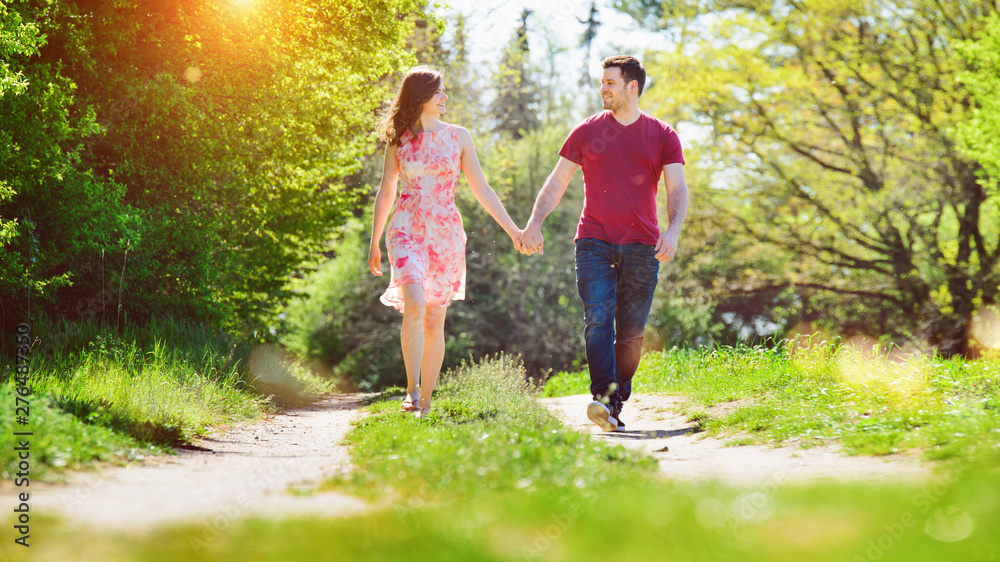 Fototapeta premium Happy young couple enjoying the sunny day in nature