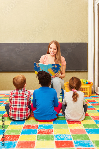 Kindergarten teacher reading aloud in kindergarten