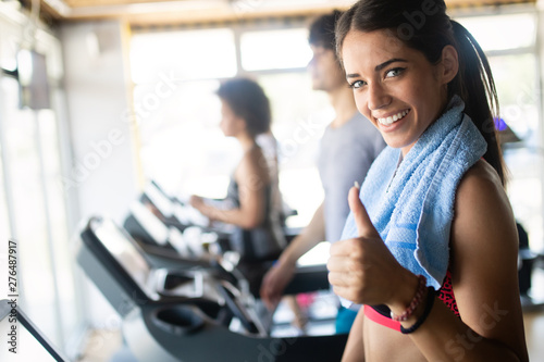 Fit sportswoman exercising and training at fitness club