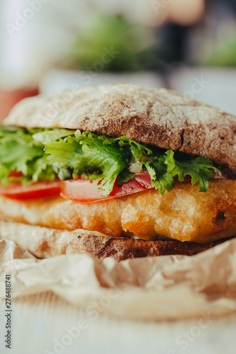 fried fish Sandwich with lettuce, tomato with tartar sauce. author's recipe street food