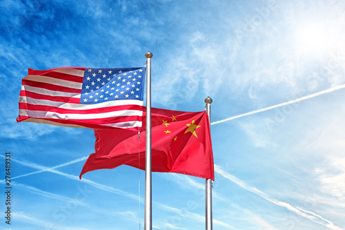 usa and china national flag waving against clouds blue sky side view of natural color of united states of america us and people republic of china state symbols isolated for design copy space template photo