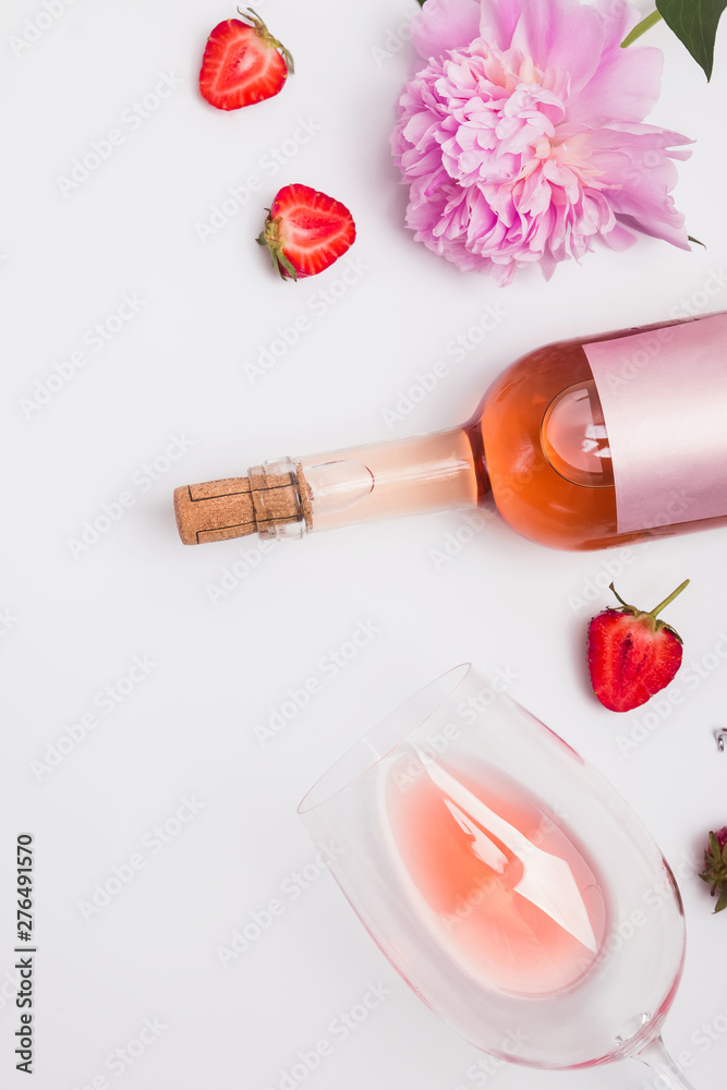 Creative summer flat lay with rose wine, delicious strawberries and beautiful peonies Creative summer flat lay with rose wine, delicious strawberries and beautiful peonies
