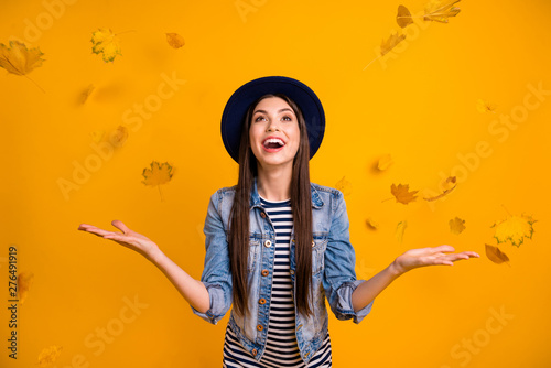 Portrait of her she nice charming attractive lovely careless optimistic cheerful cheery straight-haired lady throwing seasonal leaves having fun isolated over bright vivid shine yellow background