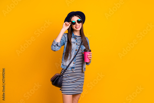 Portrait of her she nice charming cute attractive lovely cheerful cheery straight-haired lady holding in hand hot cacao cappuccino daydream isolated over bright vivid shine yellow background
