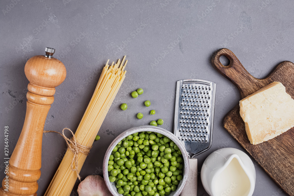 Ingredients for making spaghetti with cream and peas on the grey background, Ingredients for making spaghetti with cream and peas on the grey background,