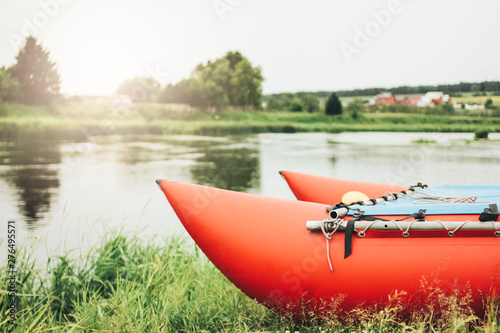 Inflatable catamaran for river rafting and fishing on grass shore