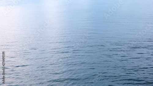 Wind blowing over water making shallow blue ripples on surface of sea.