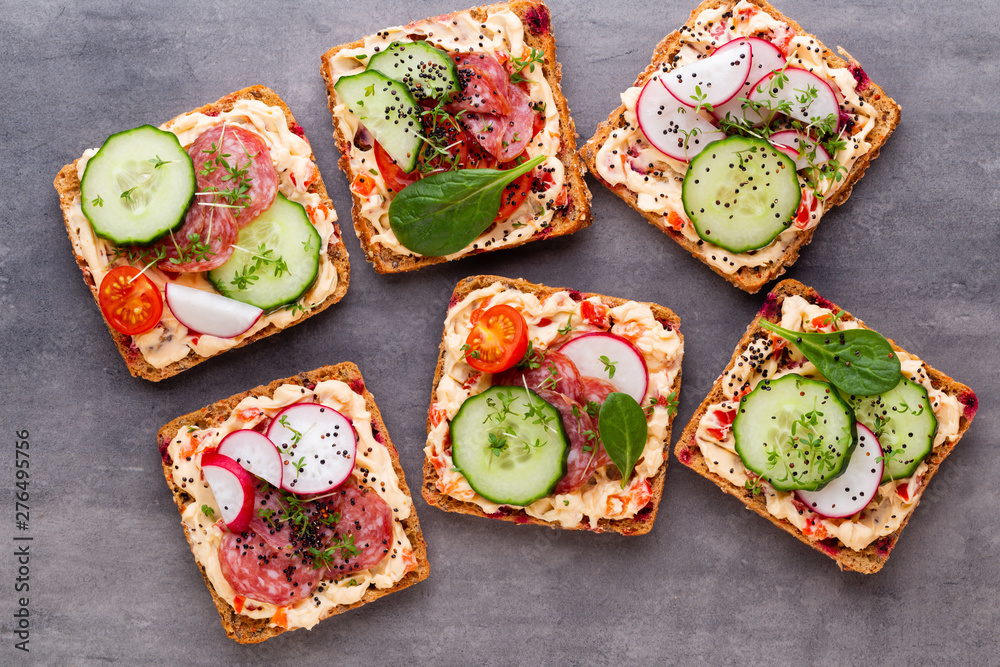 Sandwiches with cream cheese, vegetables and salami. Sandwiches with cream cheese, vegetables and salami.