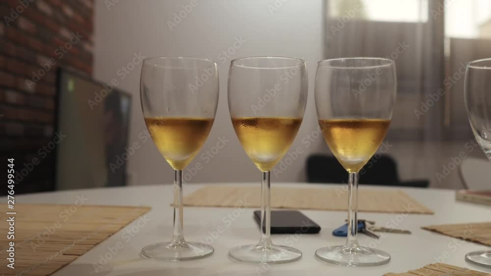 three glasses of champagne on the table in the kitchen closeup three glasses of champagne on the table in the kitchen closeup