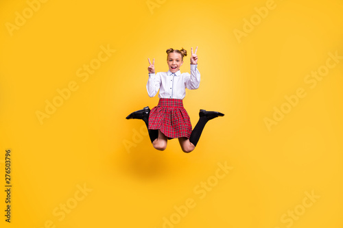 Full length body size view of her she nice attractive lovely cheerful cheery positive overjoyed pre-teen girl having fun showing v-sign isolated over bright vivid shine yellow background