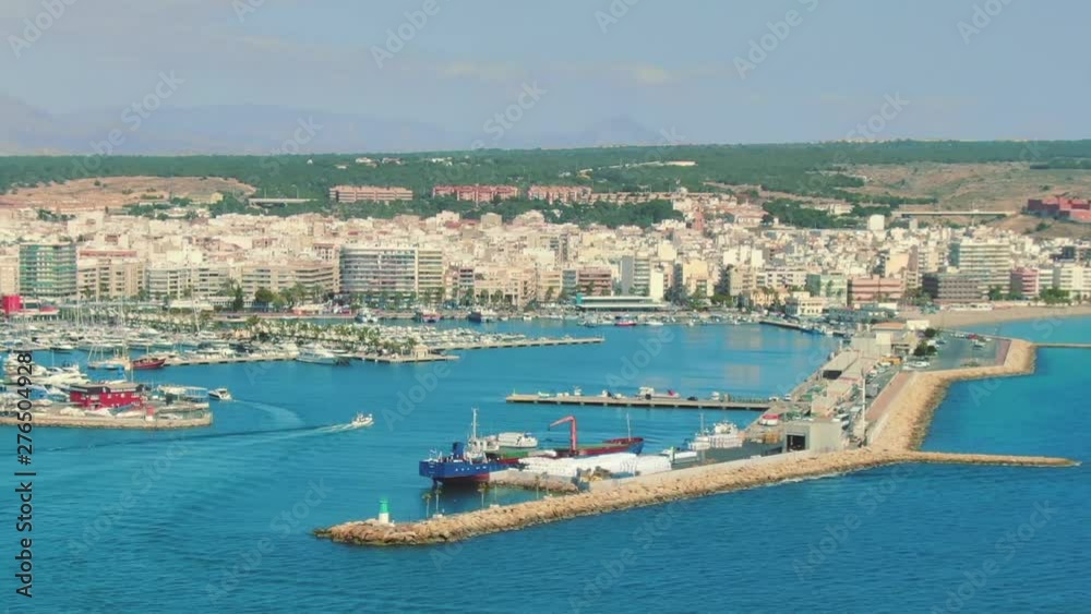 Coastal spanish town Santa Pola with marina long aerial dolly tilt up shot Coastal spanish town Santa Pola with marina long aerial dolly tilt up shot