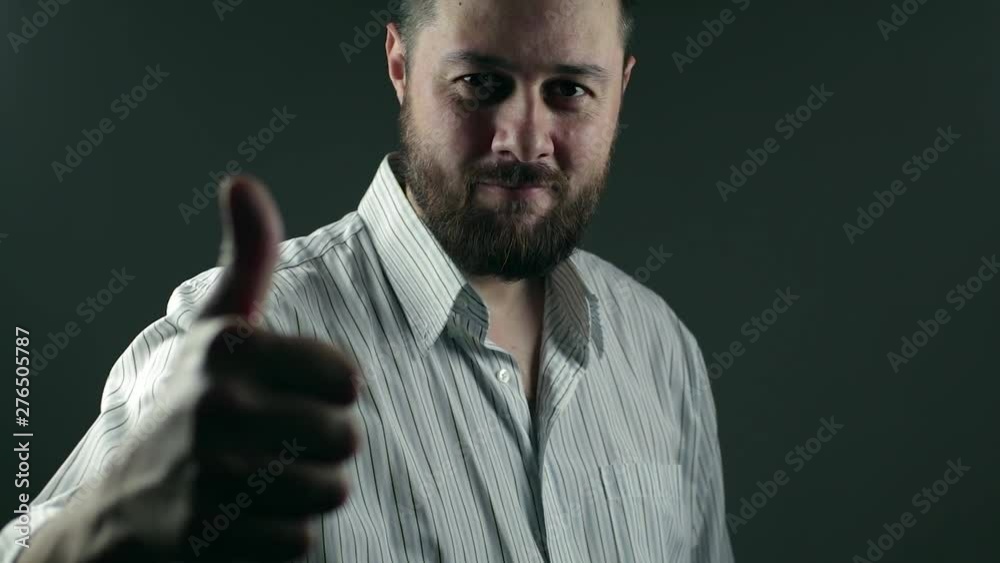 Casual beard business man walks intot he light and smilles with thumbs up for business success Casual beard business man walks intot he light and smilles with thumbs up for business success