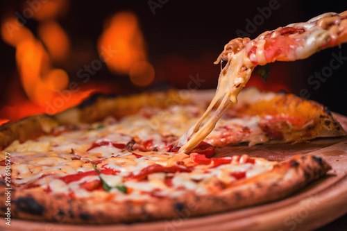 tasty pizza out of oven in restaurant kitchen