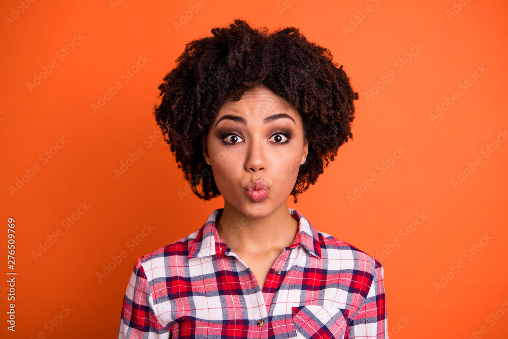 Close-up portrait of her she nice-looking attractive lovable cheerful wavy-haired lady in checked shirt sending kiss plump lips isolated on bright vivid shine orange background Close-up portrait of her she nice-looking attractive lovable cheerful wavy-haired lady in checked shirt sending kiss plump lips isolated on bright vivid shine orange background