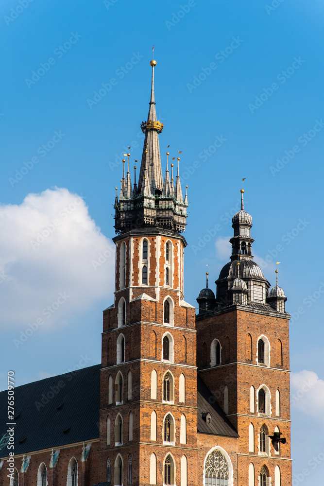 Cracow Krakow Poland - April, 2019: St Mary's Basilica Mariacki Church and The Main Market Square in the Old Town of Krakow.