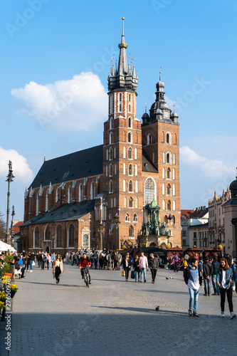 Cracow Krakow Poland - April, 2019: St Mary's Basilica Mariacki Church and The Main Market Square in the Old Town of Krakow.