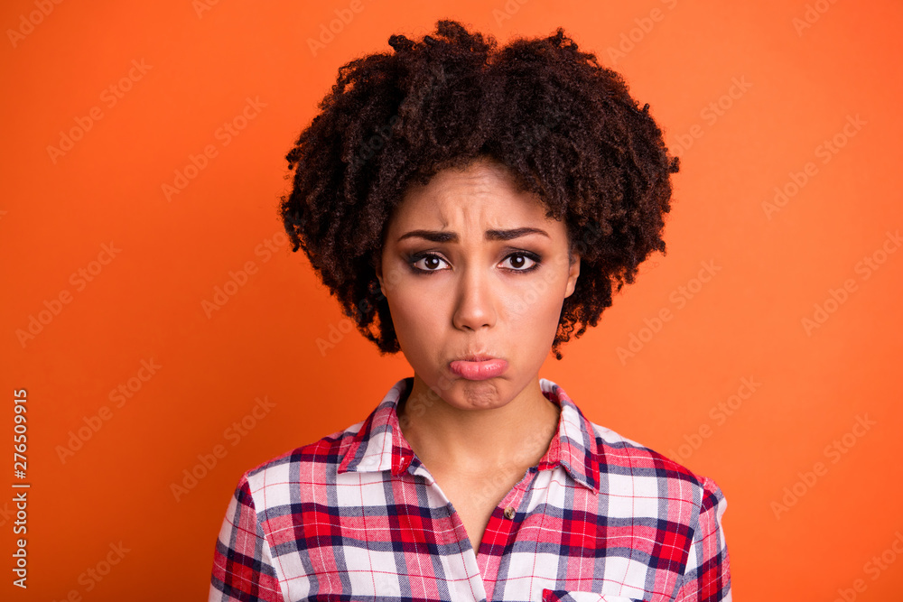 Close-up portrait of her she nice-looking attractive lovely gloomy grumpy sullen moody wavy-haired lady in checked shirt grimacing isolated on bright vivid shine orange background Close-up portrait of her she nice-looking attractive lovely gloomy grumpy sullen moody wavy-haired lady in checked shirt grimacing isolated on bright vivid shine orange background